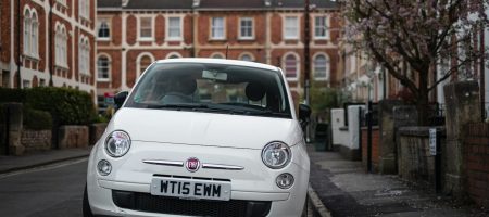 Photo white bmw car parked on sidewalk during daytime