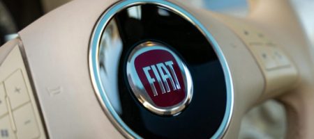 Photo by Seb Seb Detailed close-up of a Fiat car's steering wheel highlighting the logo.